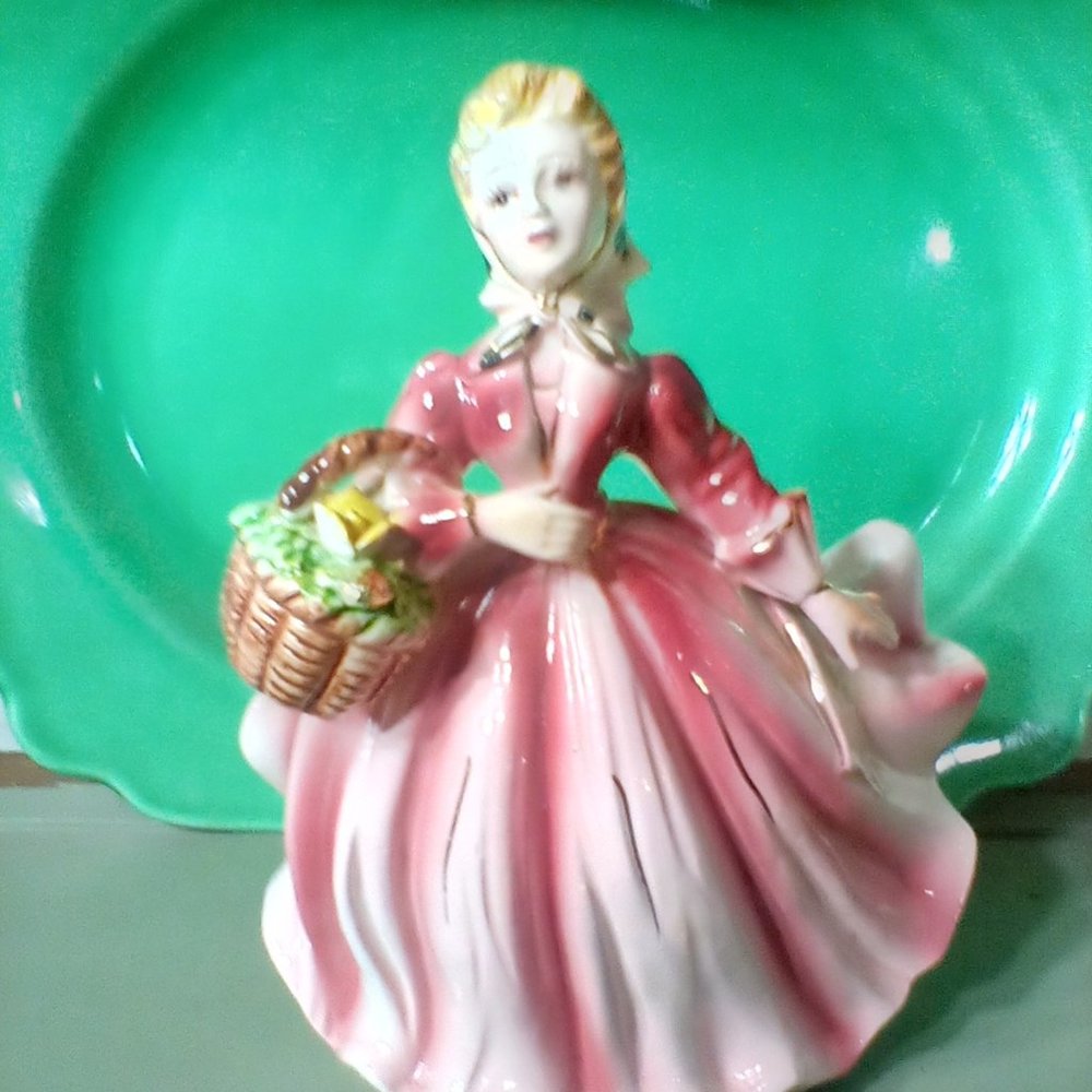 Vintage lady planter carrying flower basket